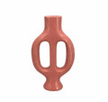 A glossy terracotta-colored ceramic vase with a unique double handle design, isolated on a solid white background.