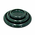 Three nested round trays or coasters in a glossy dark green glaze with fine silver speckling, shown on a plain white background.
