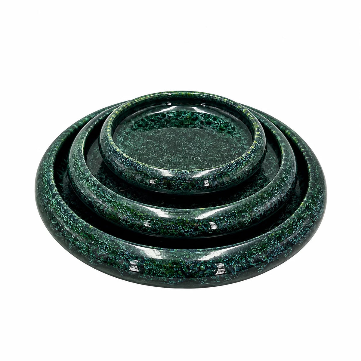 Three nested round trays or coasters in a glossy dark green glaze with fine silver speckling, shown on a plain white background.
