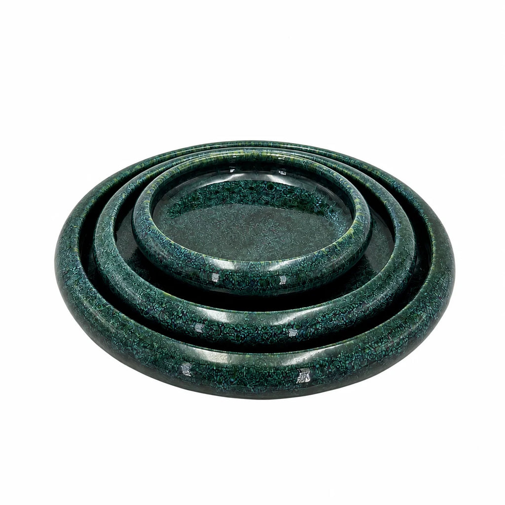 A set of three nested round ceramic trays with a glossy dark green and black speckled glaze, photographed on a solid white background.