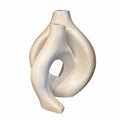 An abstract sculptural ceramic vase with a glossy finish, featuring a unique intertwined organic shape on a plain white background.