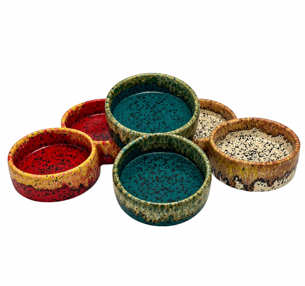 Six small round ceramic bowls with textured, speckled glazes in red, teal, green, and tan, arranged on a plain white background.
