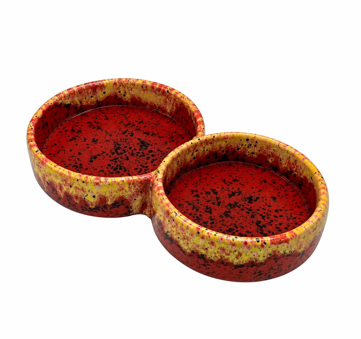 A two-bowl ceramic pet dish with a glossy red interior and a textured, speckled yellow and red exterior, shown on a plain white background.