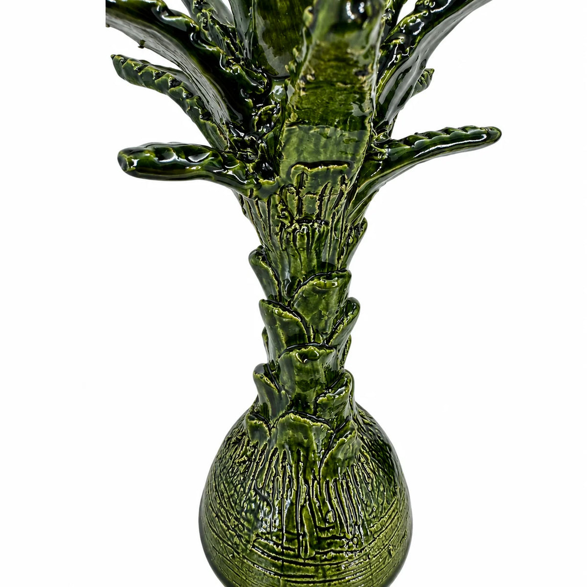 A glossy green ceramic pineapple figurine with textured, ribbed details and a rounded base, shown against a plain white background.