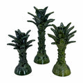 Three green palm tree-shaped ceramic candle holders with a glossy textured glaze, arranged against a plain white background.