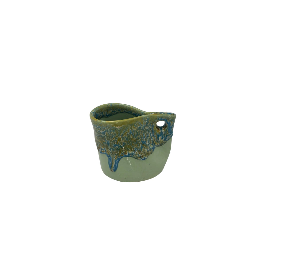 A small ceramic cup with a rounded triangular shape, featuring a textured blue and green glaze on the front and a small hole on the side, set against a plain white background.